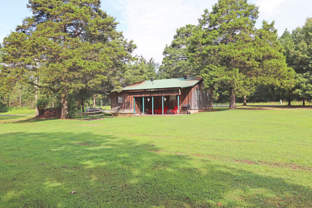 Rear exterior of Cottage in the Woods showing yard and back porch