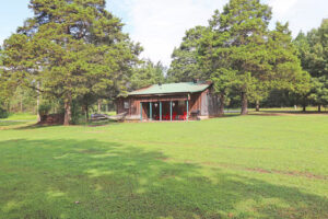 Rear exterior of Cottage in the Woods showing yard and back porch